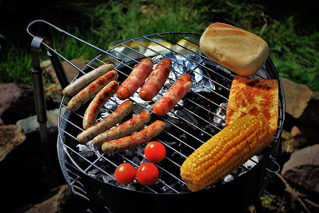 grilling corn pizza and bun on barbecue