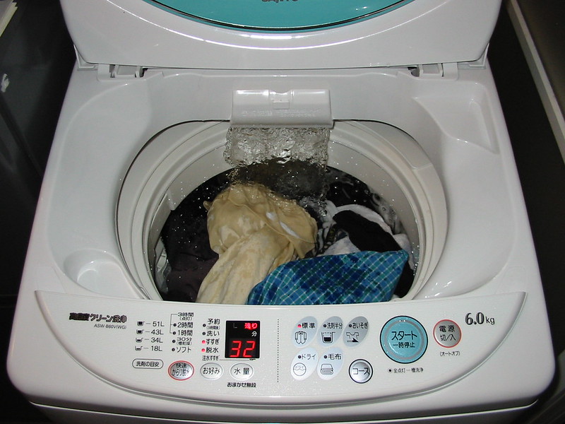 Clothes getting rinsed and dried in a washing machine
