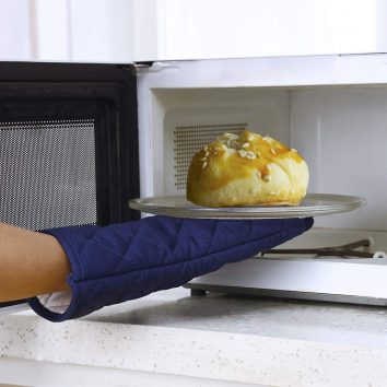 baking gloves taking out bread from microwave oven